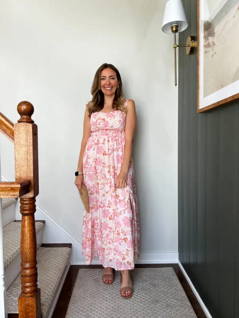 A woman standing on the stairs in her dress.