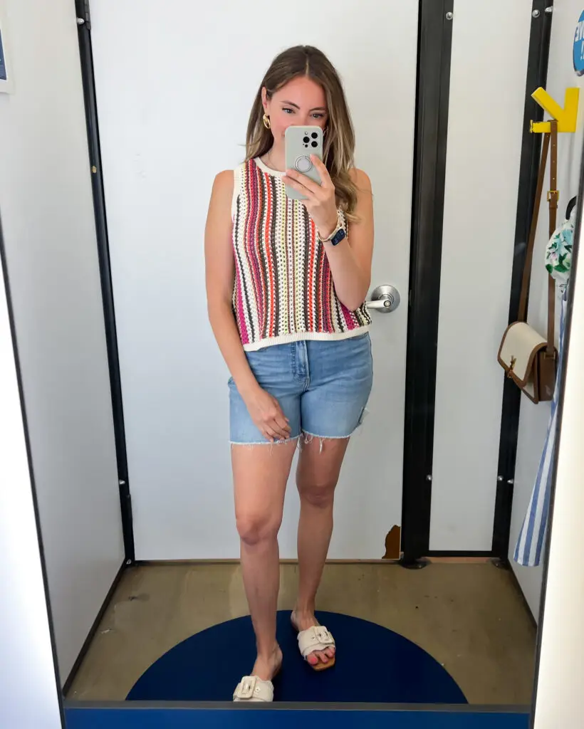 A woman taking a selfie in front of the mirror.