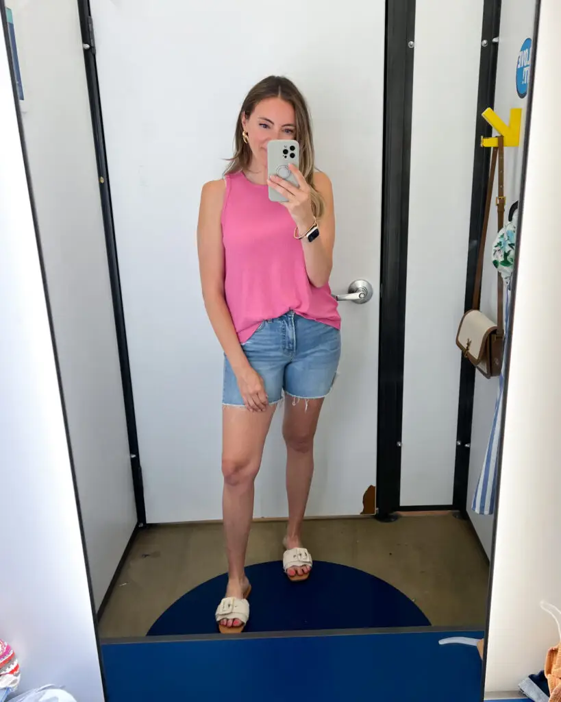 A woman taking a selfie in front of the mirror.