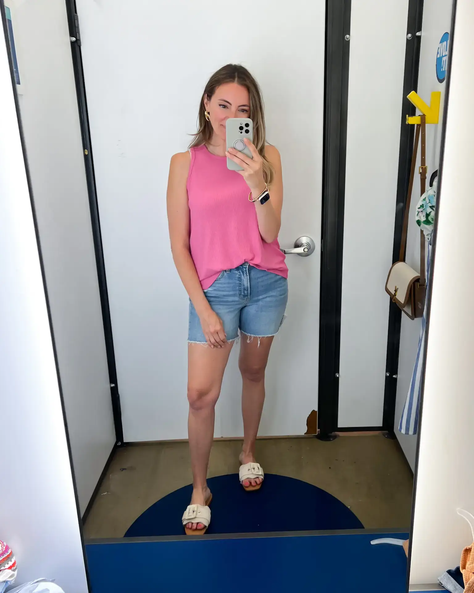A woman taking a selfie in front of the mirror.