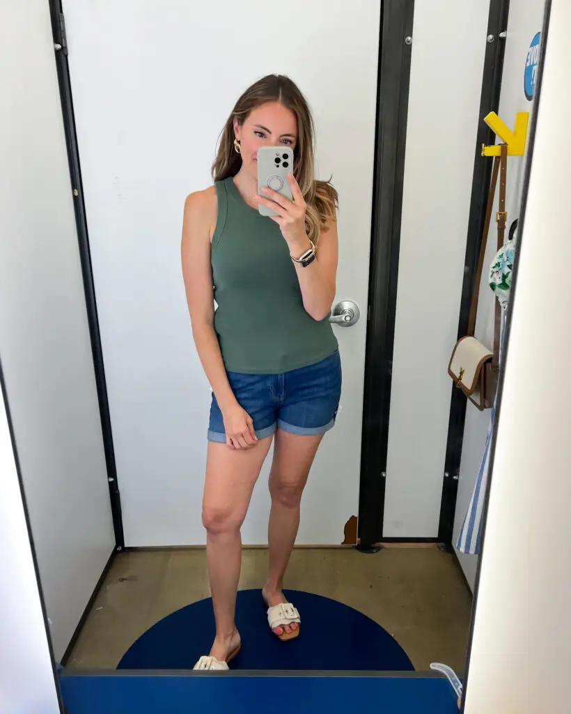 A woman taking a selfie in front of the mirror.