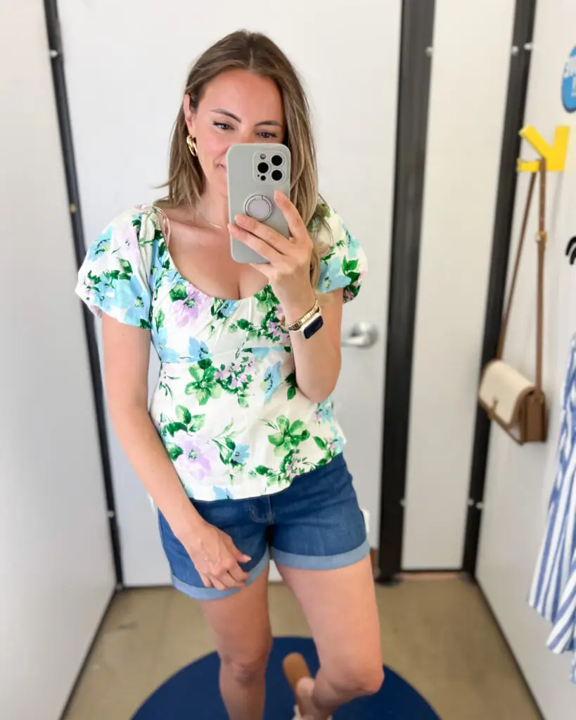A woman taking a selfie in front of the mirror.