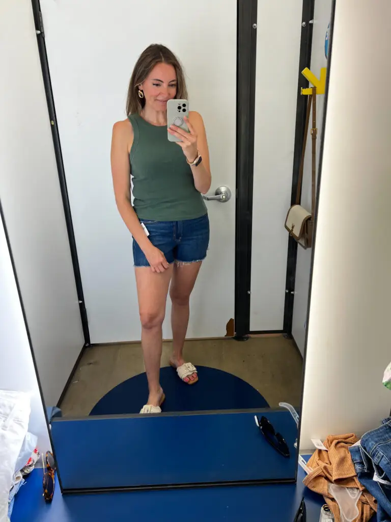 A woman taking a selfie in front of the mirror.