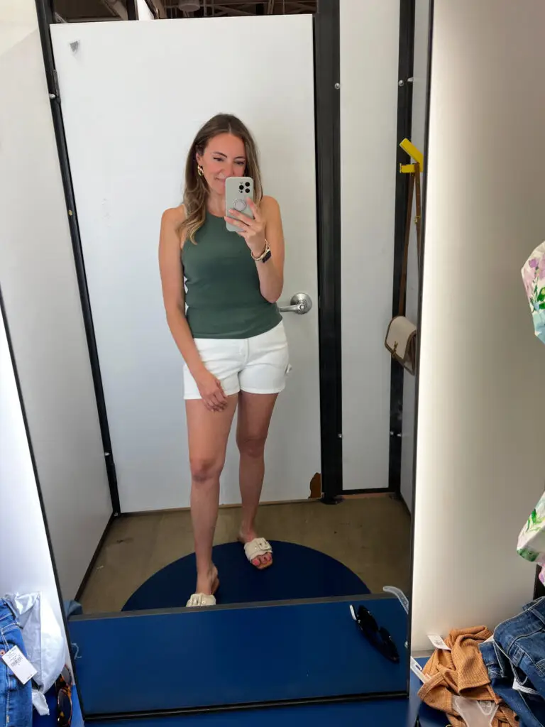 A woman taking a selfie in front of the mirror.