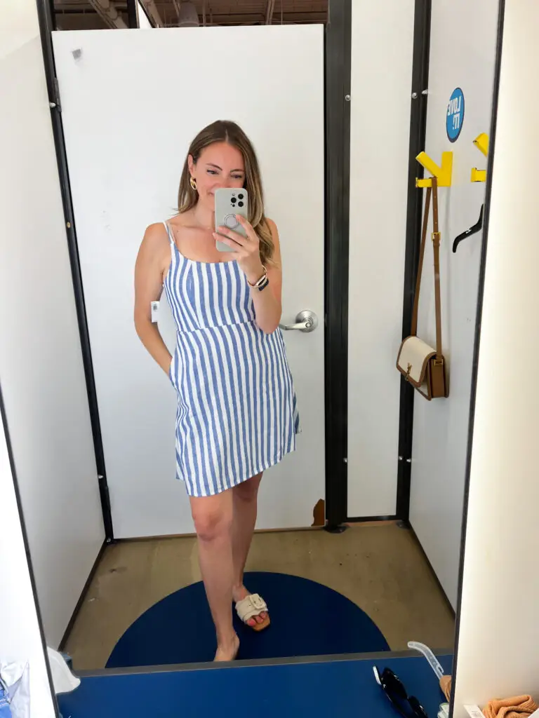 A woman taking a selfie in front of the mirror.