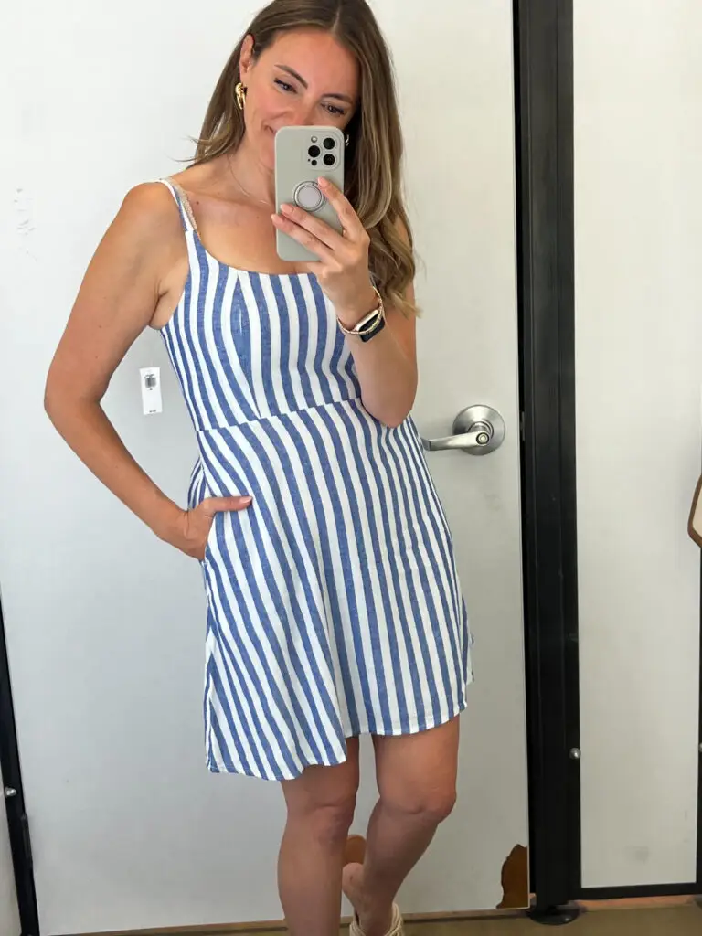 A woman taking a selfie in front of the mirror.