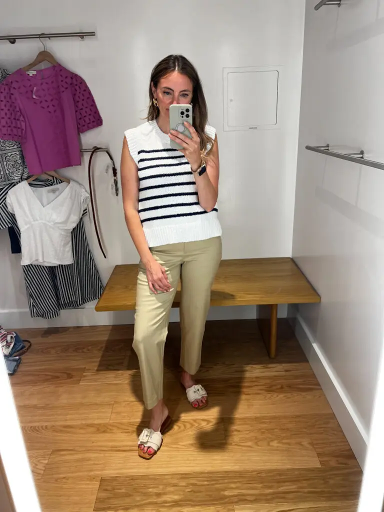 A woman taking a selfie in front of a mirror.