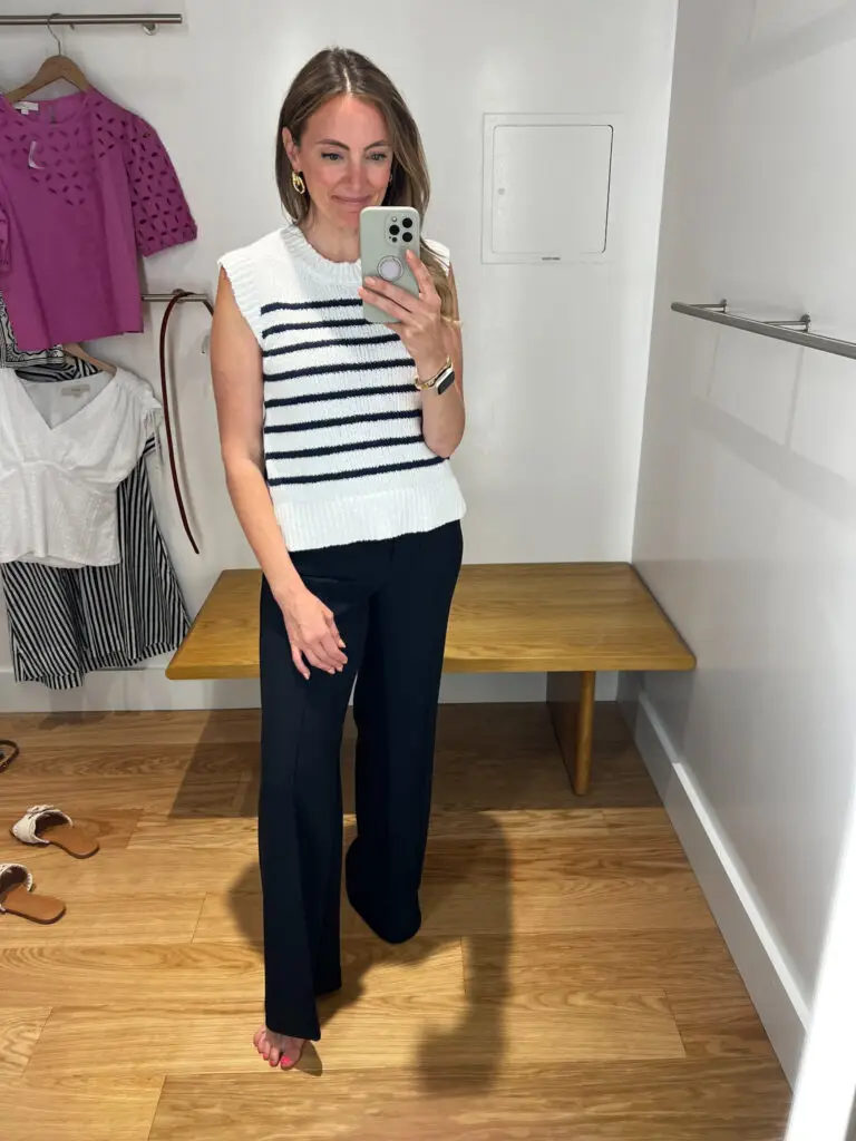 A woman taking a selfie in front of a mirror.