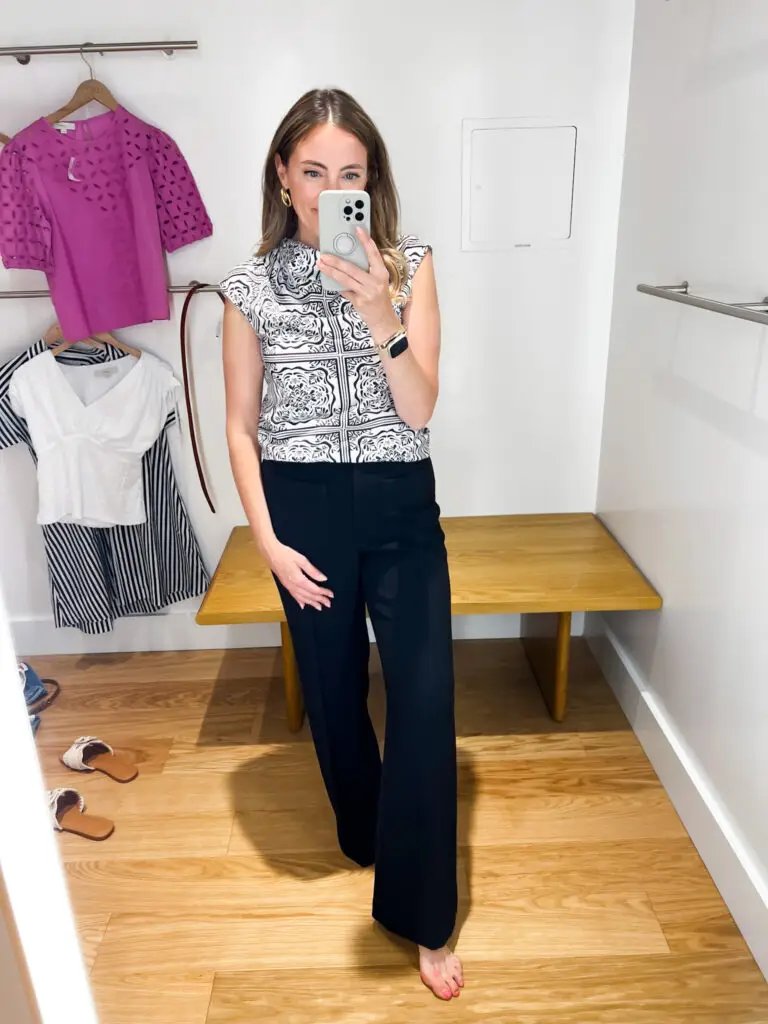 A woman taking a selfie in front of a mirror.