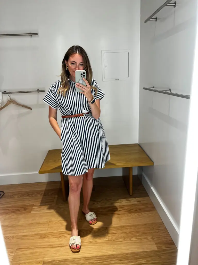 A woman taking a selfie in front of a mirror.