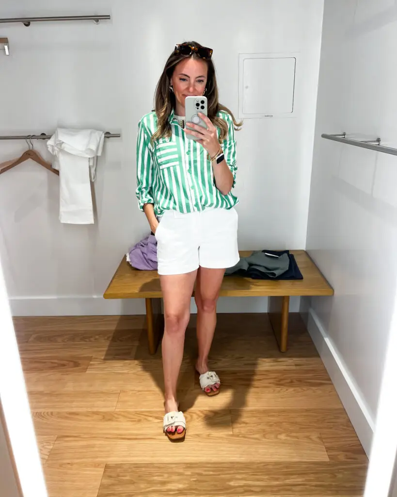A woman taking a selfie in front of the mirror.