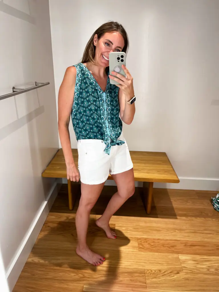 A woman taking a selfie in front of a mirror.