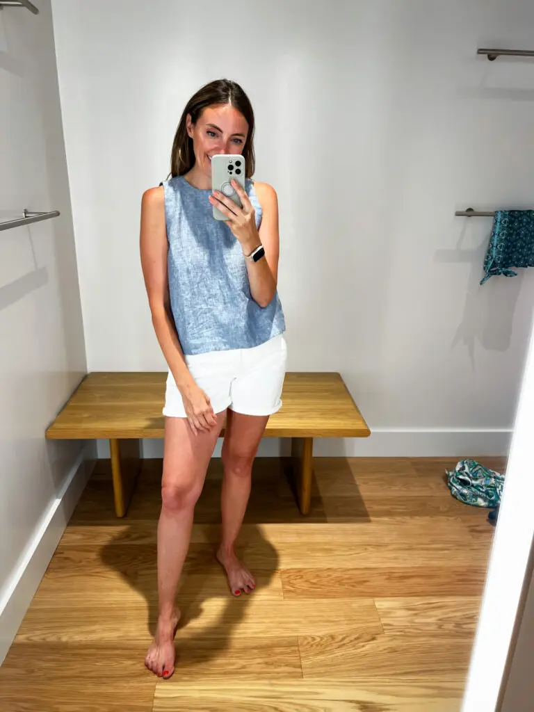 A woman taking a selfie in front of the mirror.