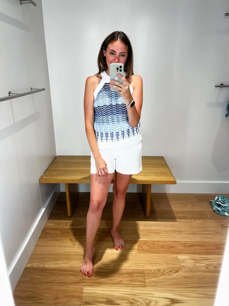 A woman taking a selfie in front of the mirror.