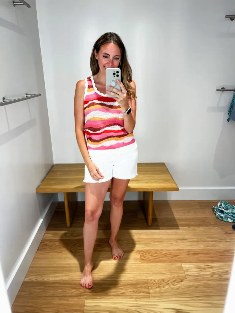 A woman taking a selfie in front of the mirror.
