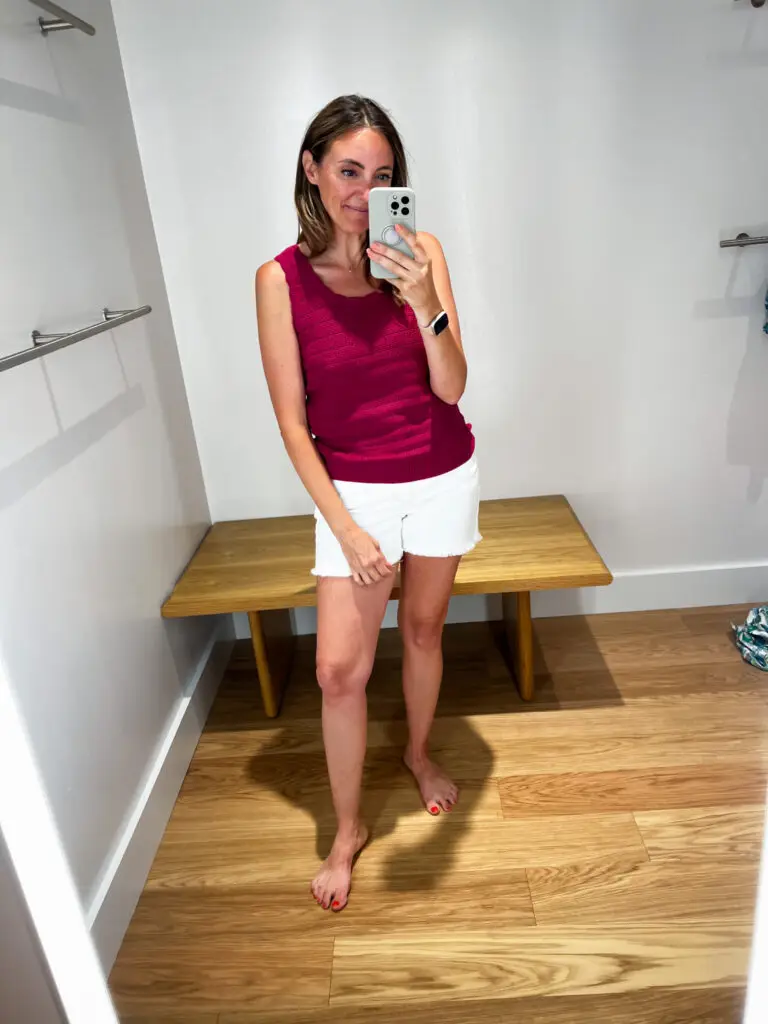 A woman taking a selfie in front of the mirror.