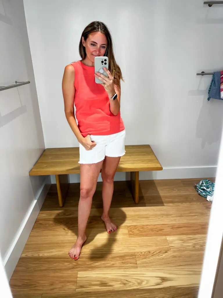 A woman taking a selfie in front of the mirror.