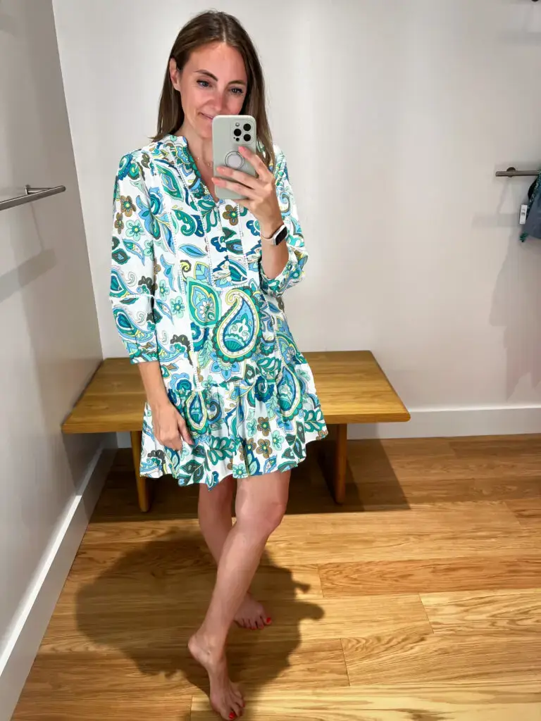 A woman taking a selfie in front of the mirror.
