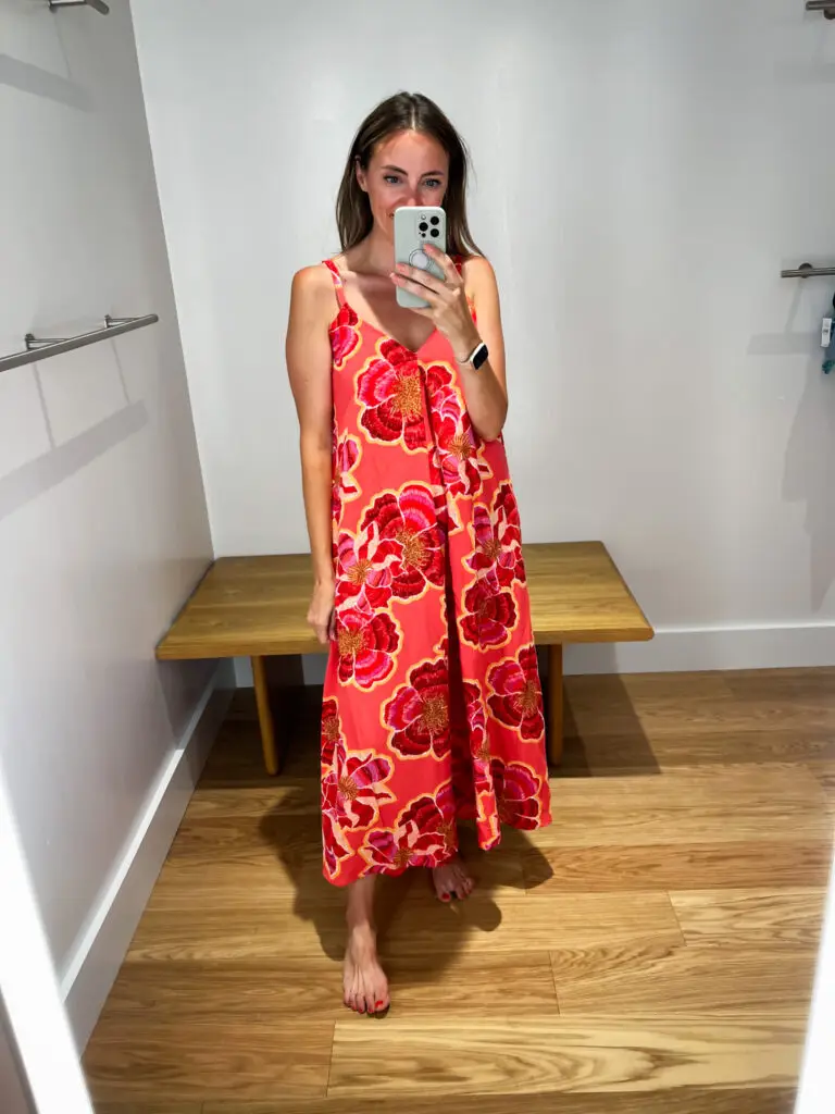 A woman taking a selfie in front of the mirror.
