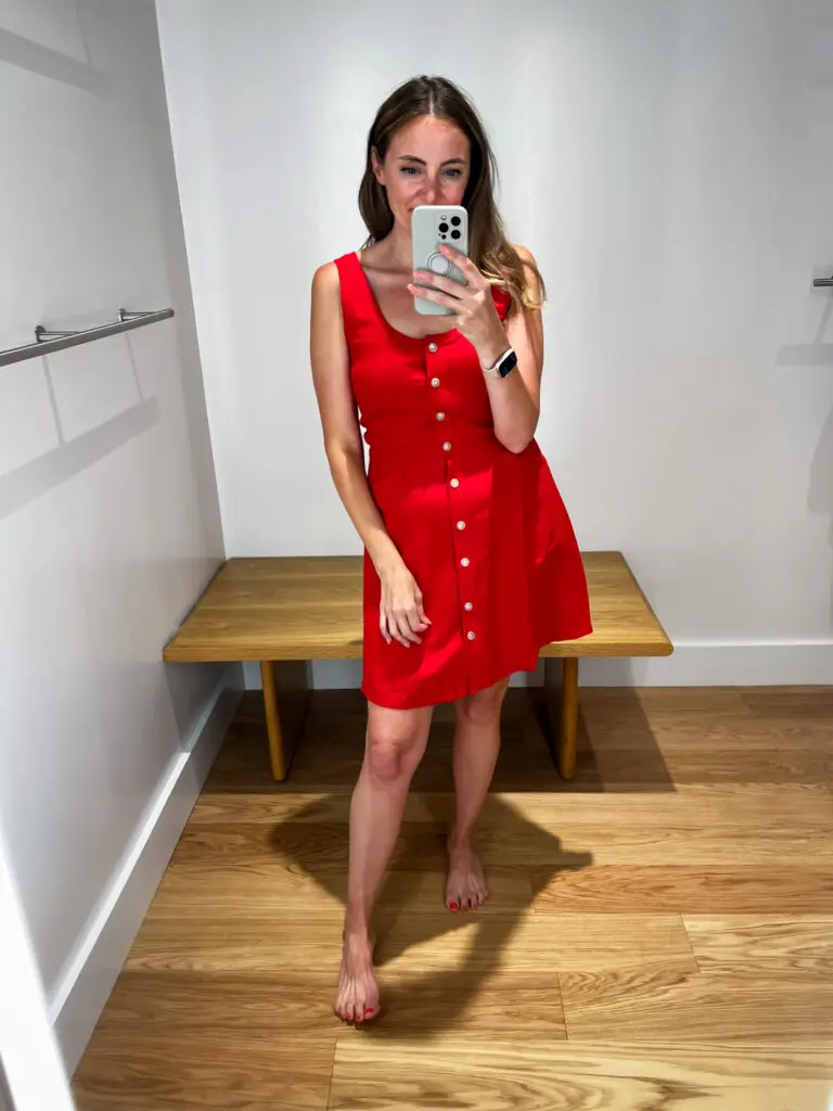 A woman taking a selfie in front of a mirror.