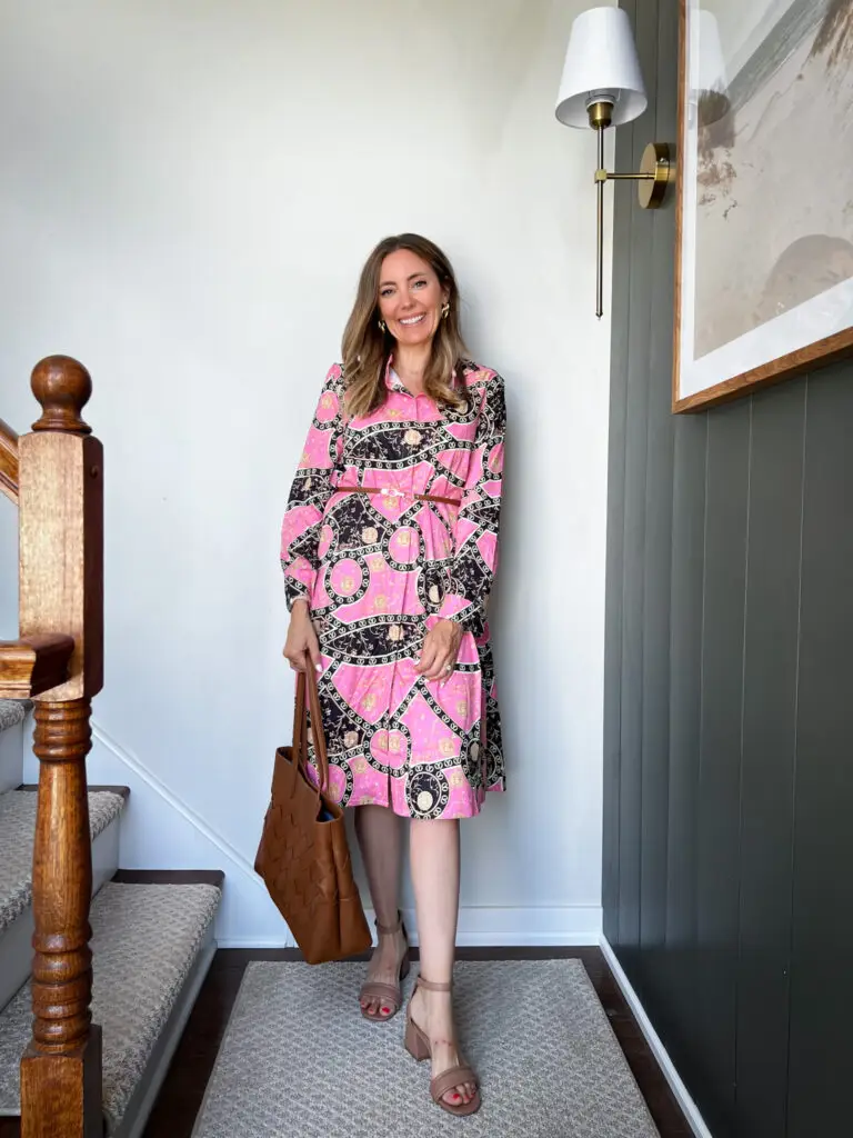 A woman standing on the stairs wearing a dress