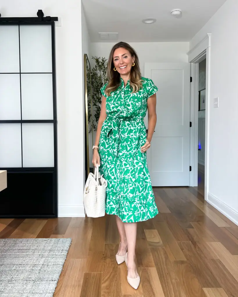 A woman in green dress standing on the floor.