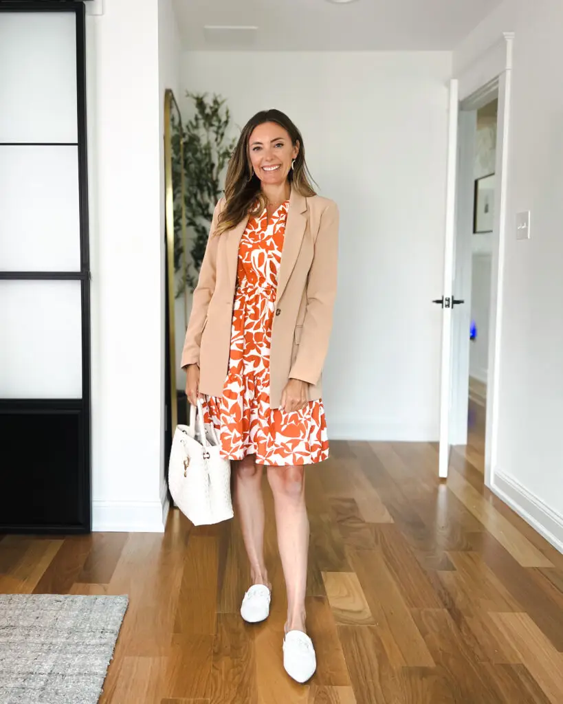 A woman standing in front of a door wearing white shoes.