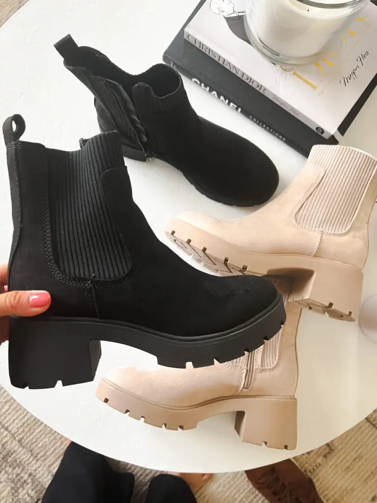 A person is holding onto the side of their boots