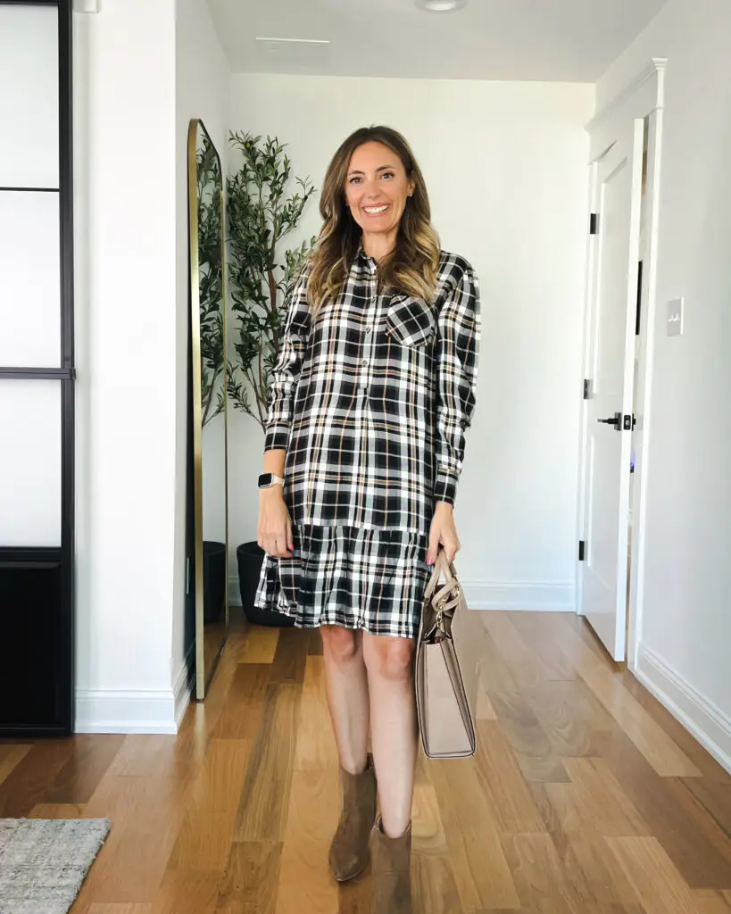 A woman in plaid dress standing on the floor.