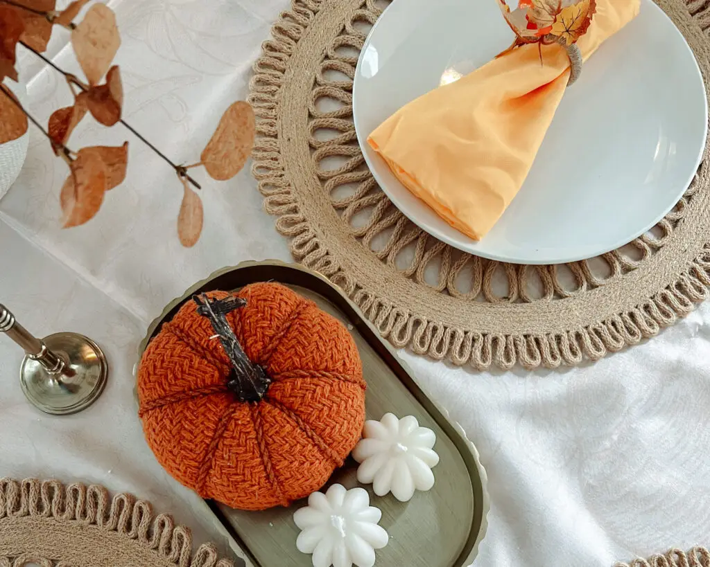 Simple-Thanksgiving-Table-Settings-and-Decor - Sweet Motherly A table with plates, candles and pumpkins on it.