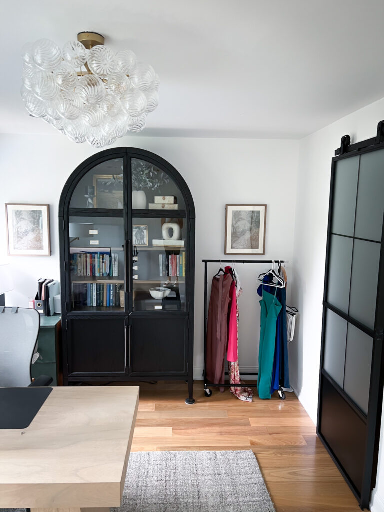 Neutral home office design with mix of functional furniture, vertical storage, and cozy decor accents