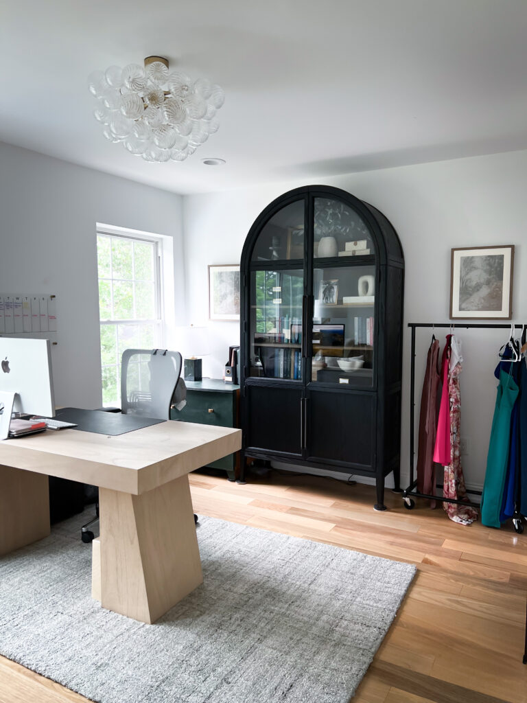 Open-concept home office with CB2 desk, Amazon barn doors, and vertical Arhaus cabinet storage