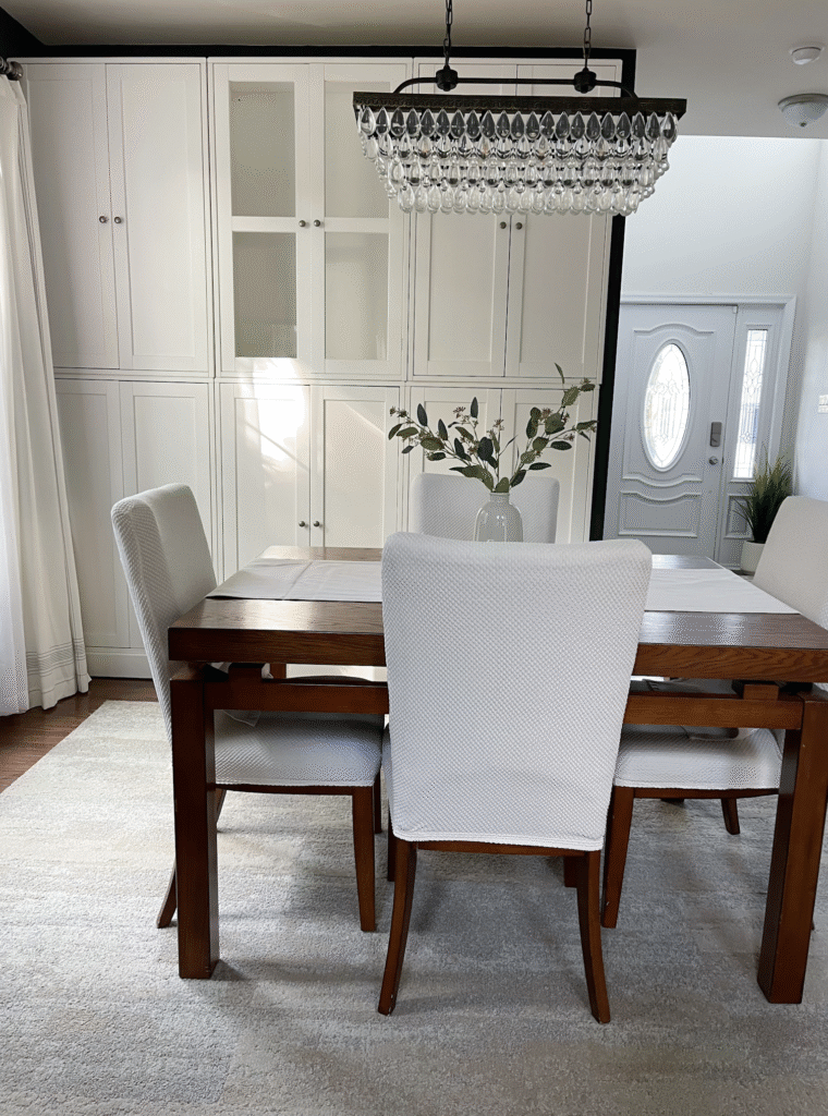 White Ikea cabinets in a bright dining room, storage hack before painting for a lighter airy look.