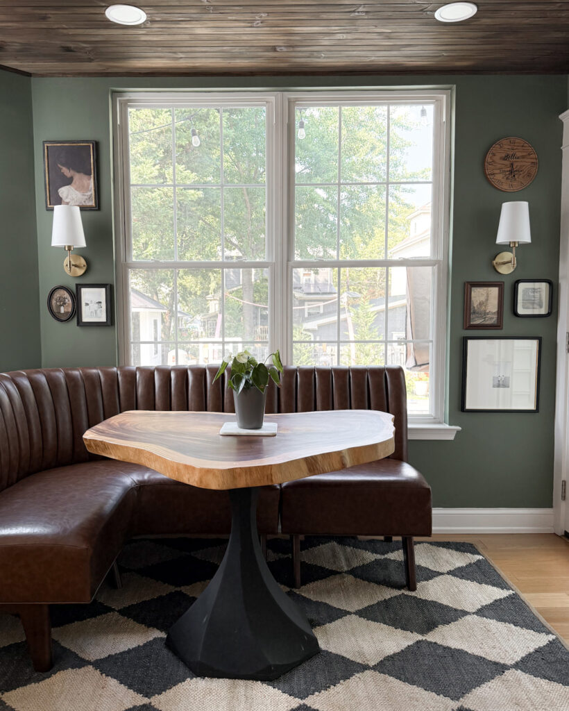 IMG_1456 3 - Sweet Motherly Cozy dining nook with built-in bench, round black pedestal table, and simple fall centerpiece with vase and stems