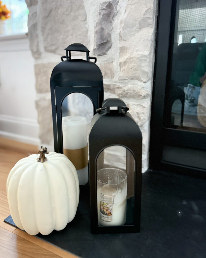 IMG_4387 - Sweet Motherly Black lanterns with white candles and white pumpkin on stone fireplace hearth for fall decor