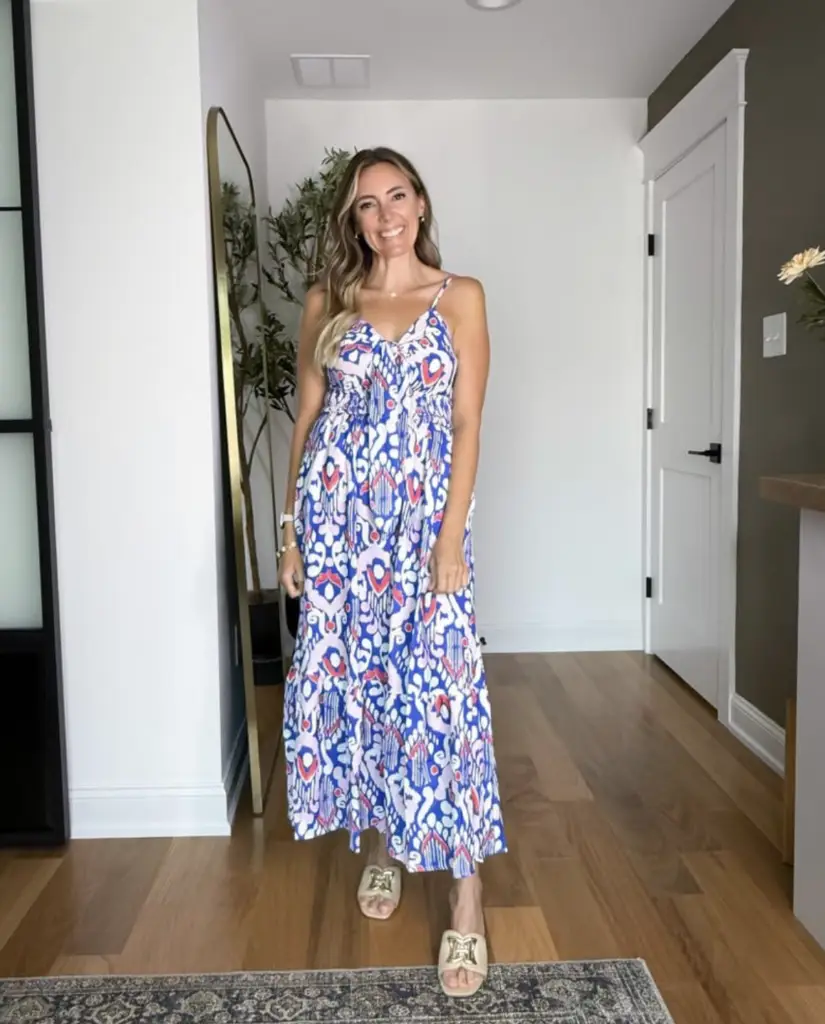 Screenshot 2026-02-02 at 100016 AM - Sweet Motherly Woman wearing a blue and pink printed midi dress with neutral slide sandals, styled for easy vacation outfits and casual summer evenings.