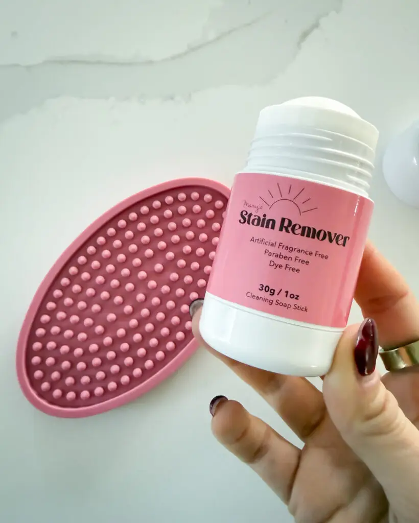 Pink portable laundry stain remover stick with silicone scrubber, a handy family travel essential from Amazon for treating stains while traveling.