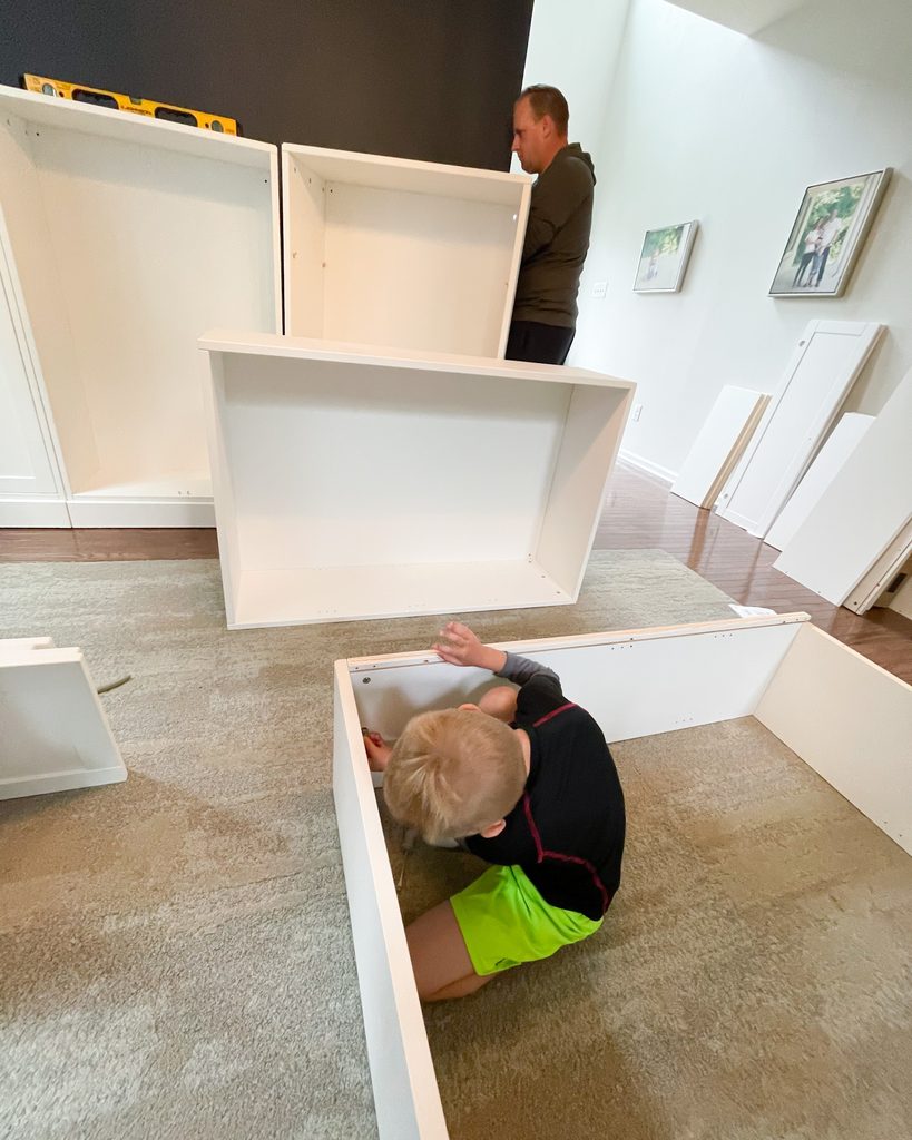 DIY IKEA Havsta cabinet assembly in progress for a built-in storage wall