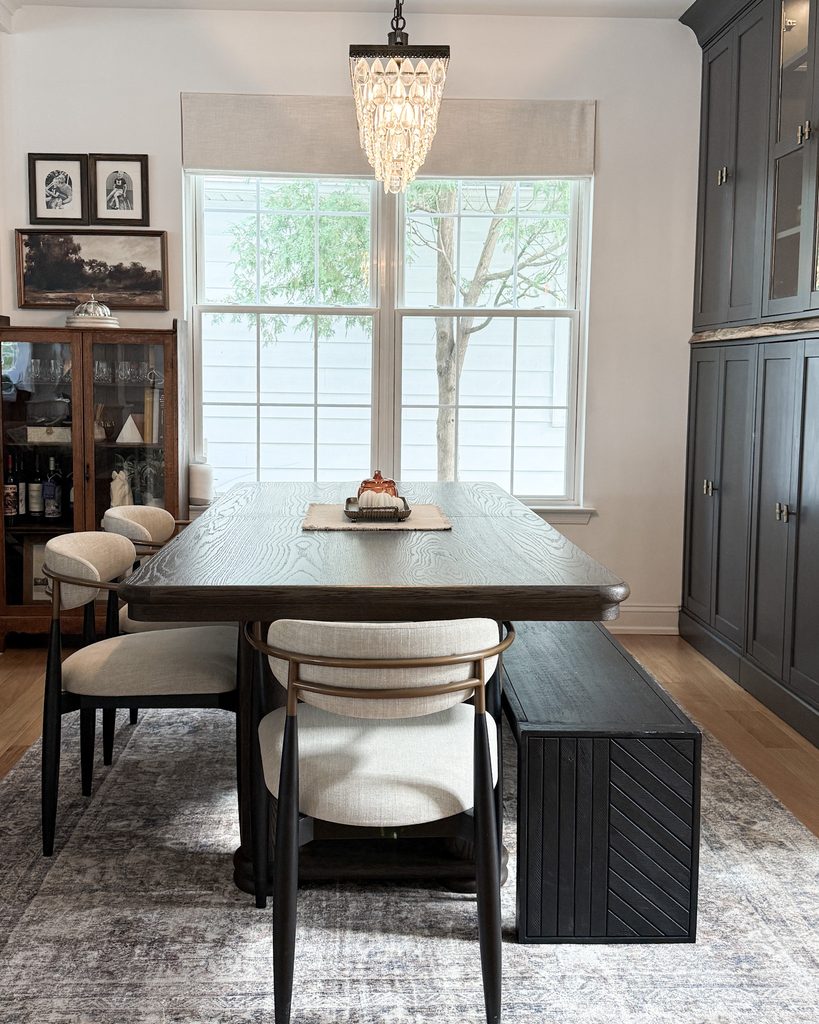 IKEA Havsta cabinets painted Iron Ore with crown molding and reclaimed wood, styled as custom built-ins in a dining room
