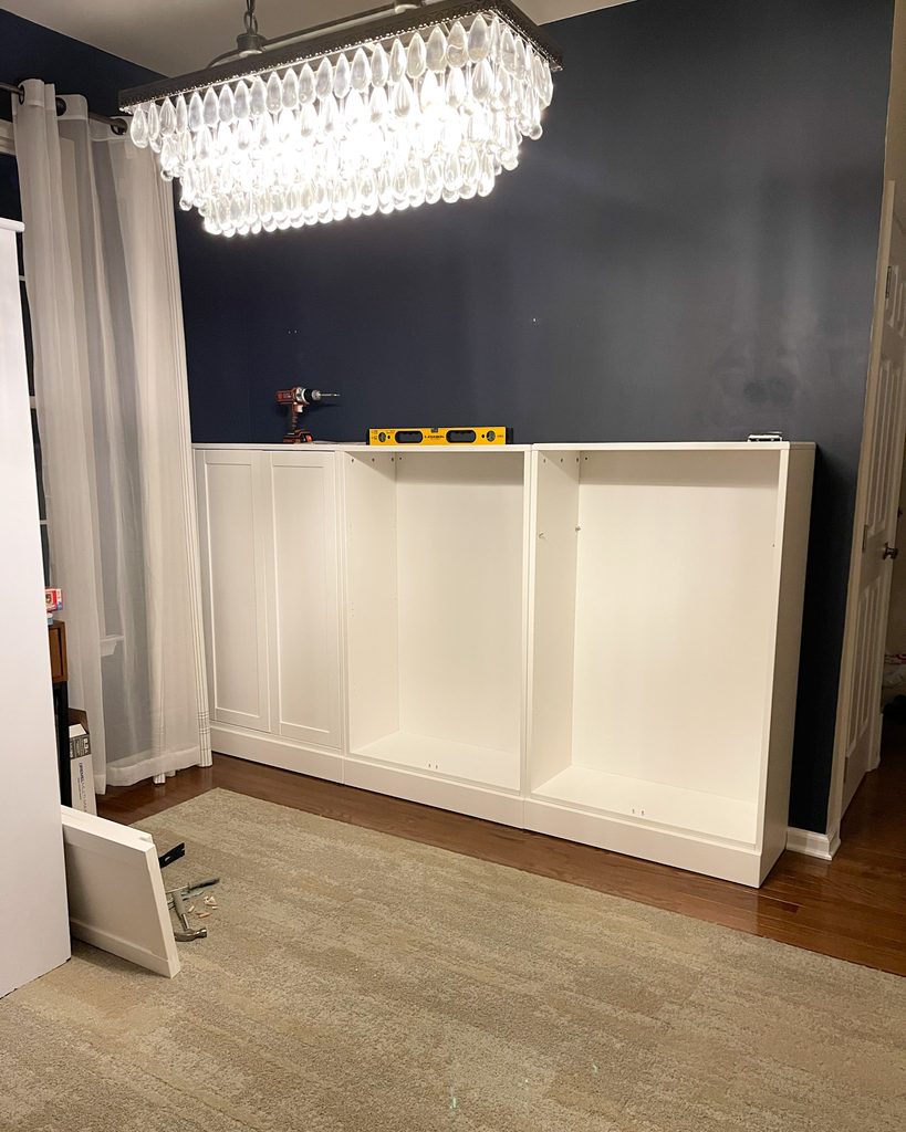 DIY IKEA Havsta cabinet installation in progress for a built-in storage wall