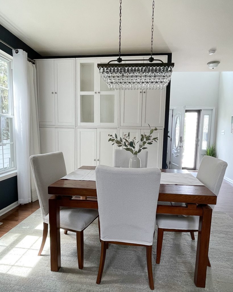 White IKEA Havsta cabinets in a dining room before painting