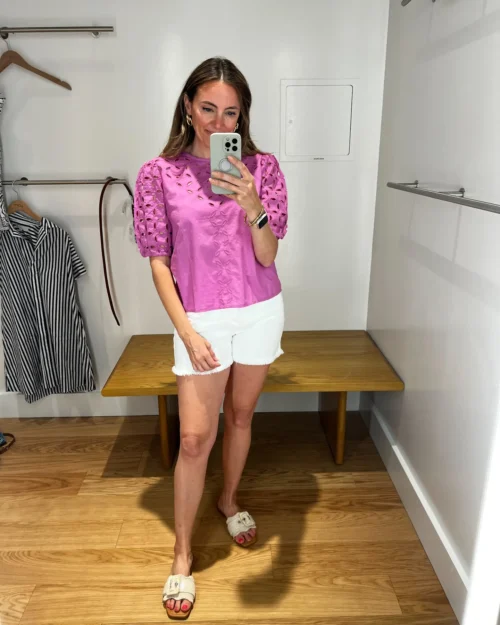 A woman taking a selfie in front of a mirror.