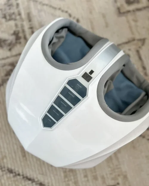 Amber glass essential oil bottles with a wooden incense tray and spa accessories on a textured white background—featured in Sweet Motherly’s Mother’s Day gift guide.